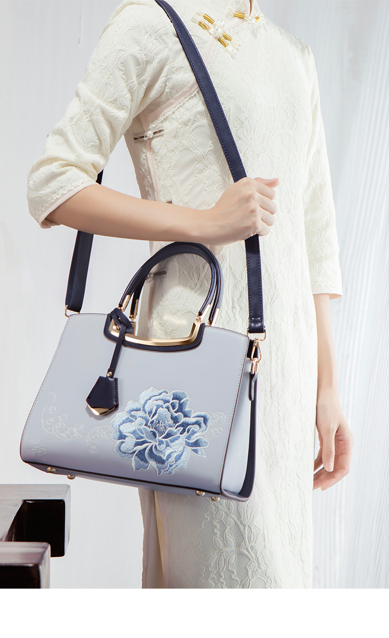 Ladies Elegant Burgundy Handbag with Floral Embroidery And Gold-Tone Hardware